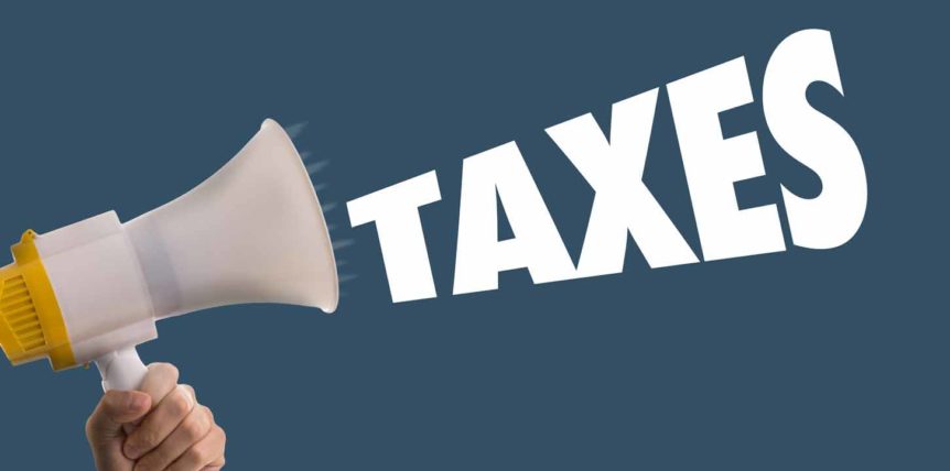 megaphone shouting the word taxes on a navy background