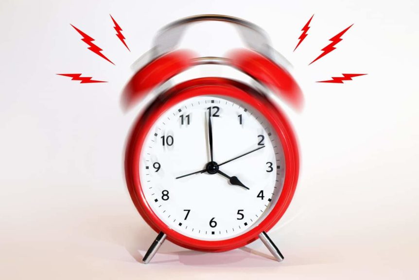 Vibrating red alarm clock