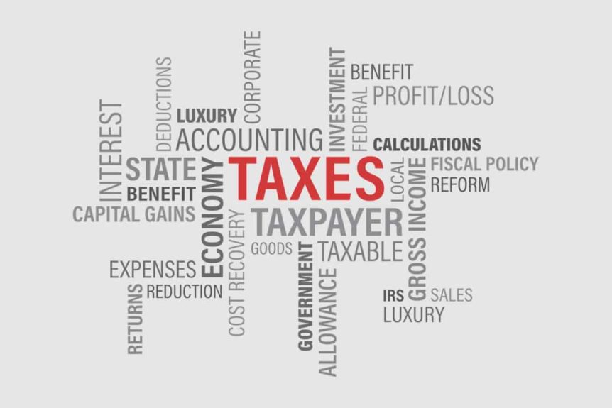 word bubble with taxes in red all caps font surrounded by financial and tax terms